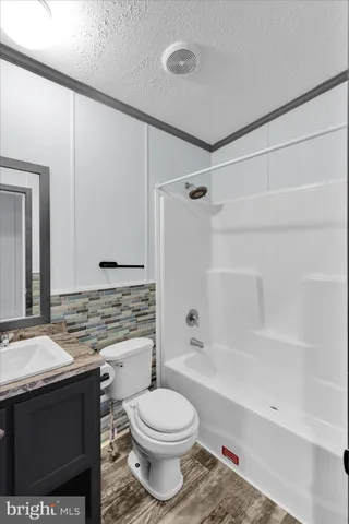 a bathroom with a sink toilet vanity and shower