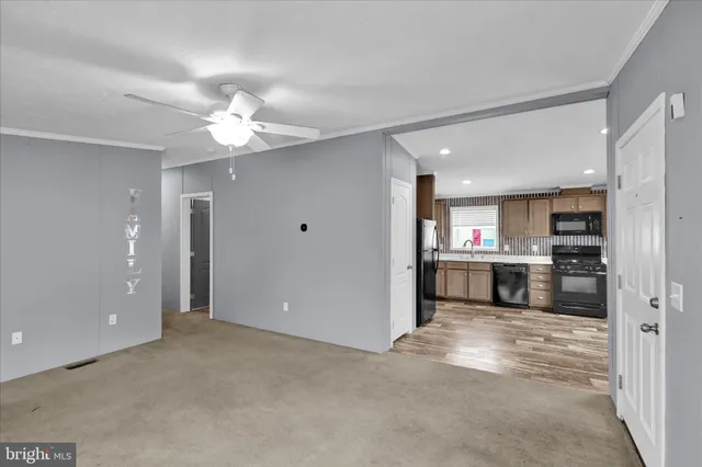 a view of kitchen with refrigerator and a sink