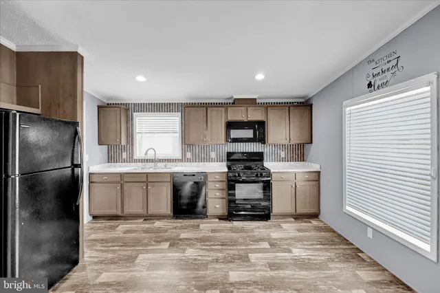 a kitchen with stainless steel appliances a refrigerator sink and stove