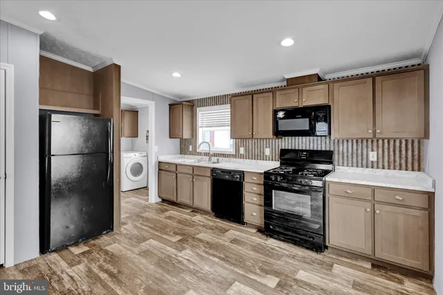 a kitchen with stainless steel appliances granite countertop a refrigerator sink and stove