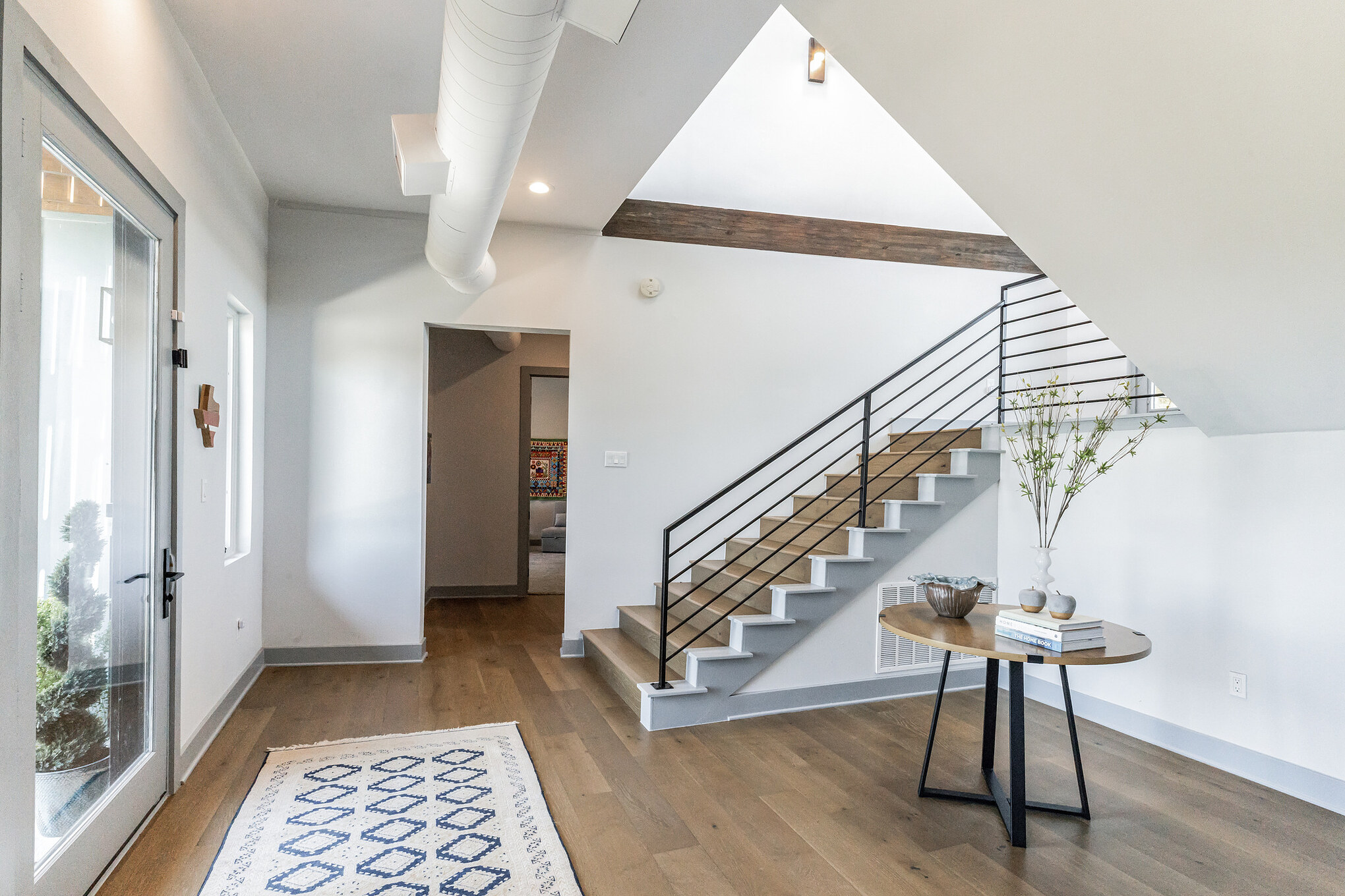 4227 Eck Lane Austin, TX 78734 - Photo 12 of 30 Foyer featuring wood finished floors, beamed ceiling, stairway, and recessed lighting