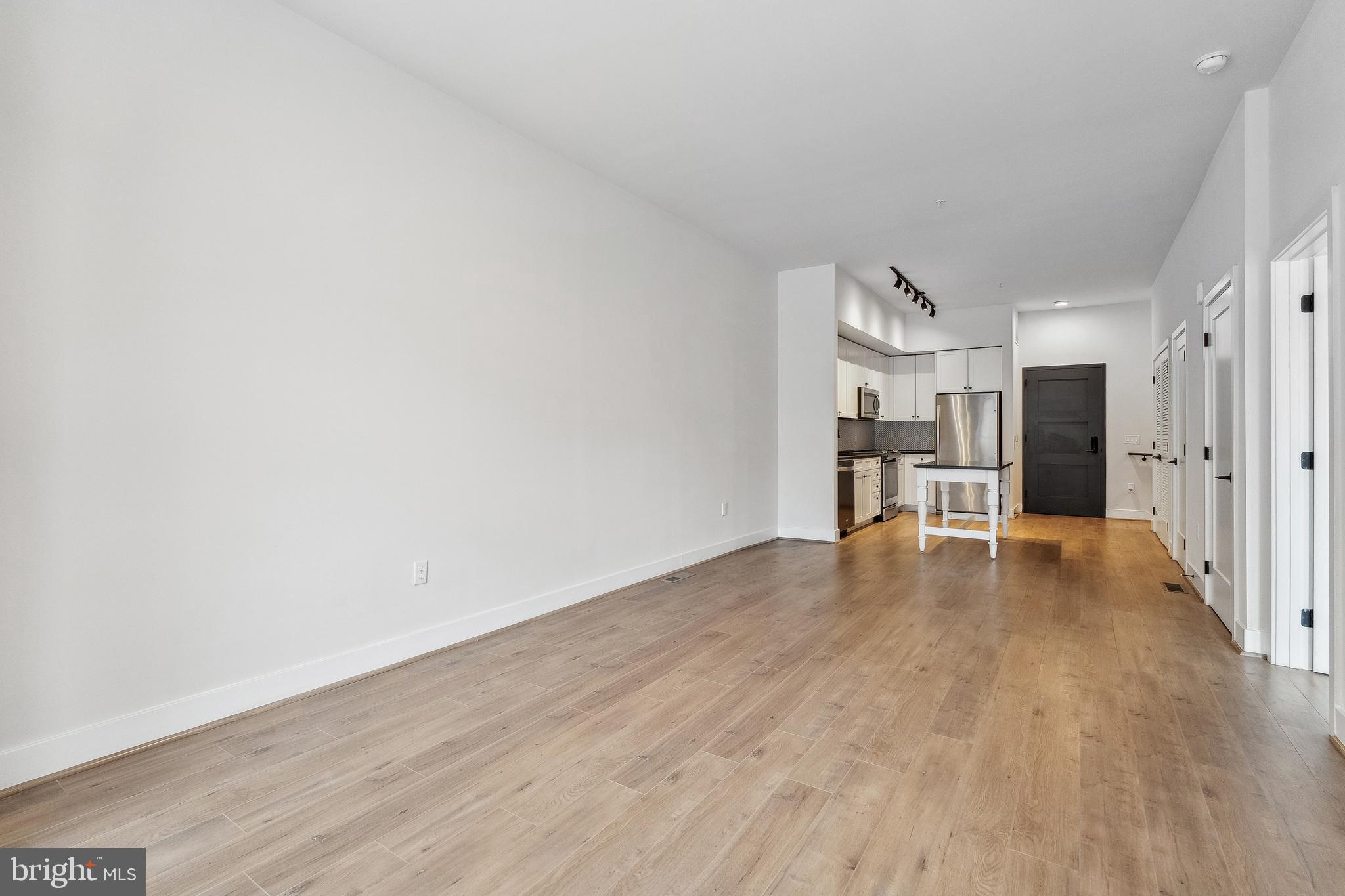 1339 E Street Southeast, Unit 209 Washington, DC 20003 - Photo 12 of 35 a view of a livingroom with wooden floor and furniture