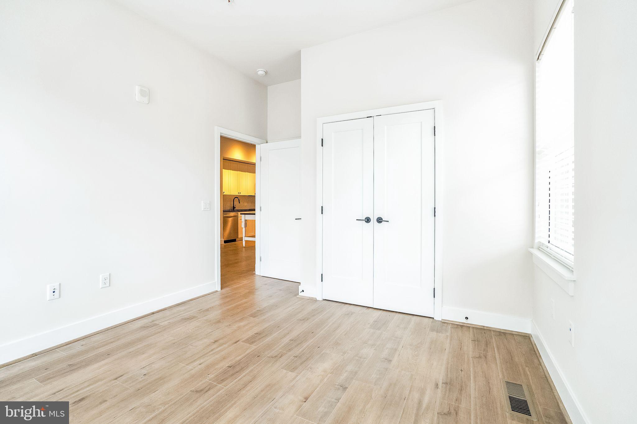 1339 E Street Southeast, Unit 209 Washington, DC 20003 - Photo 19 of 35 an empty room with wooden floor and closet