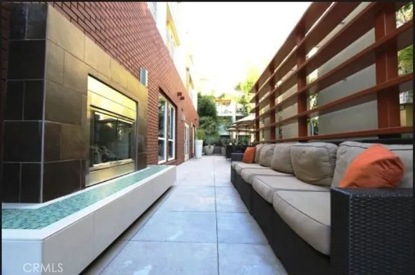a view of a patio with couches and potted plants