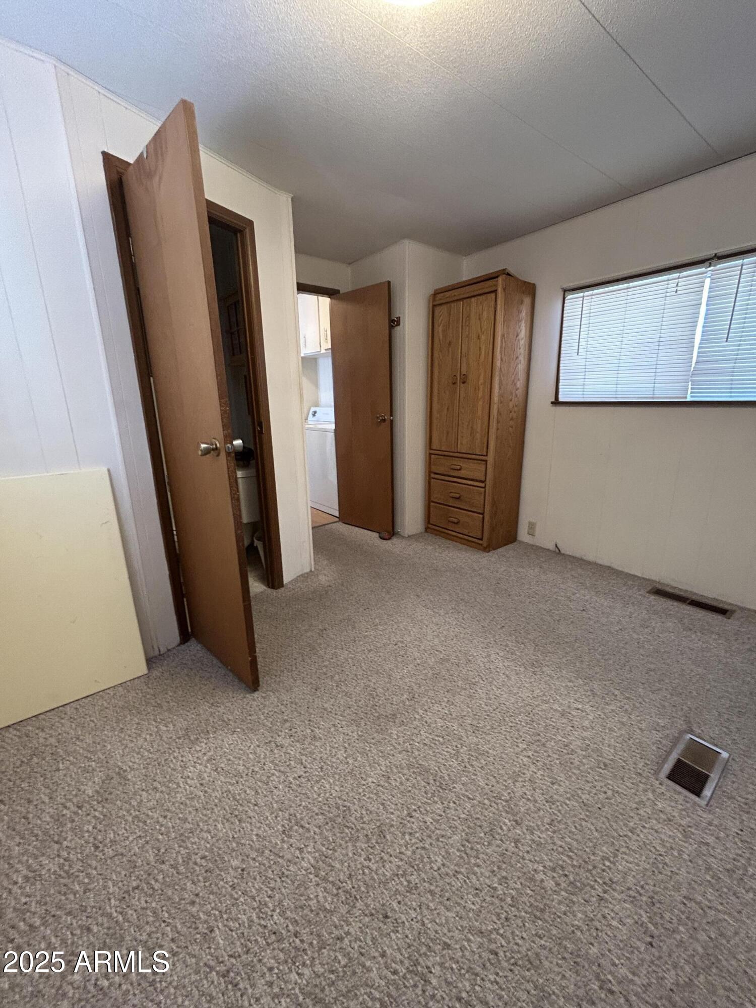 10220 East Apache Trail, Unit 28 Apache Junction, AZ 85120 - Photo 14 of 18 a view of an empty room with a fireplace