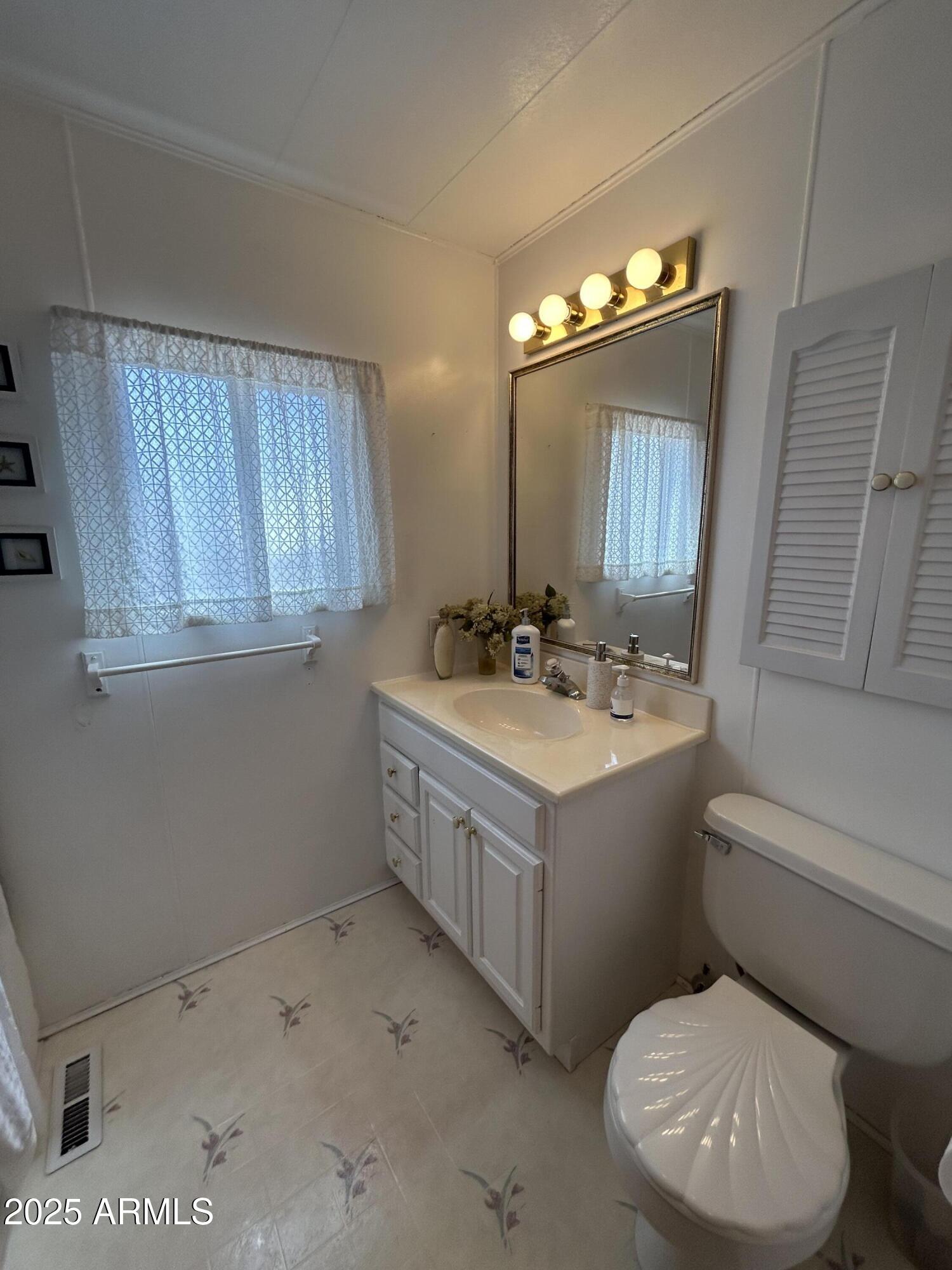10220 East Apache Trail, Unit 28 Apache Junction, AZ 85120 - Photo 16 of 18 a bathroom with a sink vanity granite toilet and a mirror