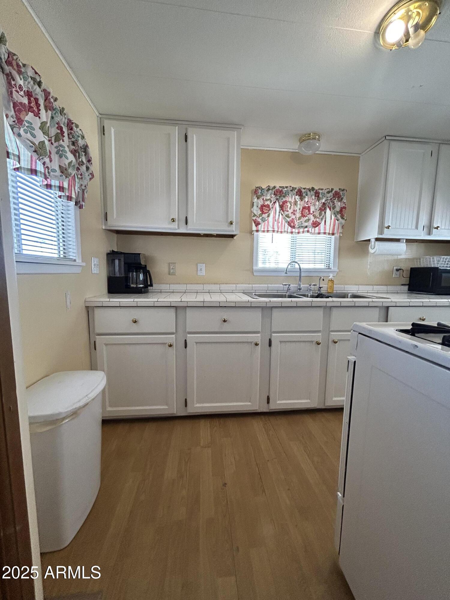 10220 East Apache Trail, Unit 28 Apache Junction, AZ 85120 - Photo 6 of 18 a kitchen with a sink a stove and cabinets