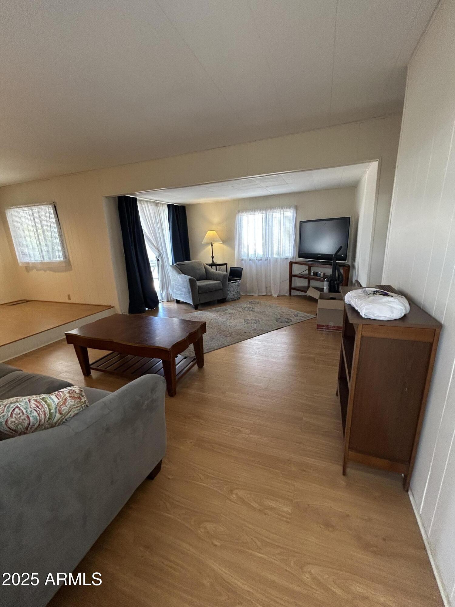 10220 East Apache Trail, Unit 28 Apache Junction, AZ 85120 - Photo 8 of 18 a living room with furniture and a flat screen tv