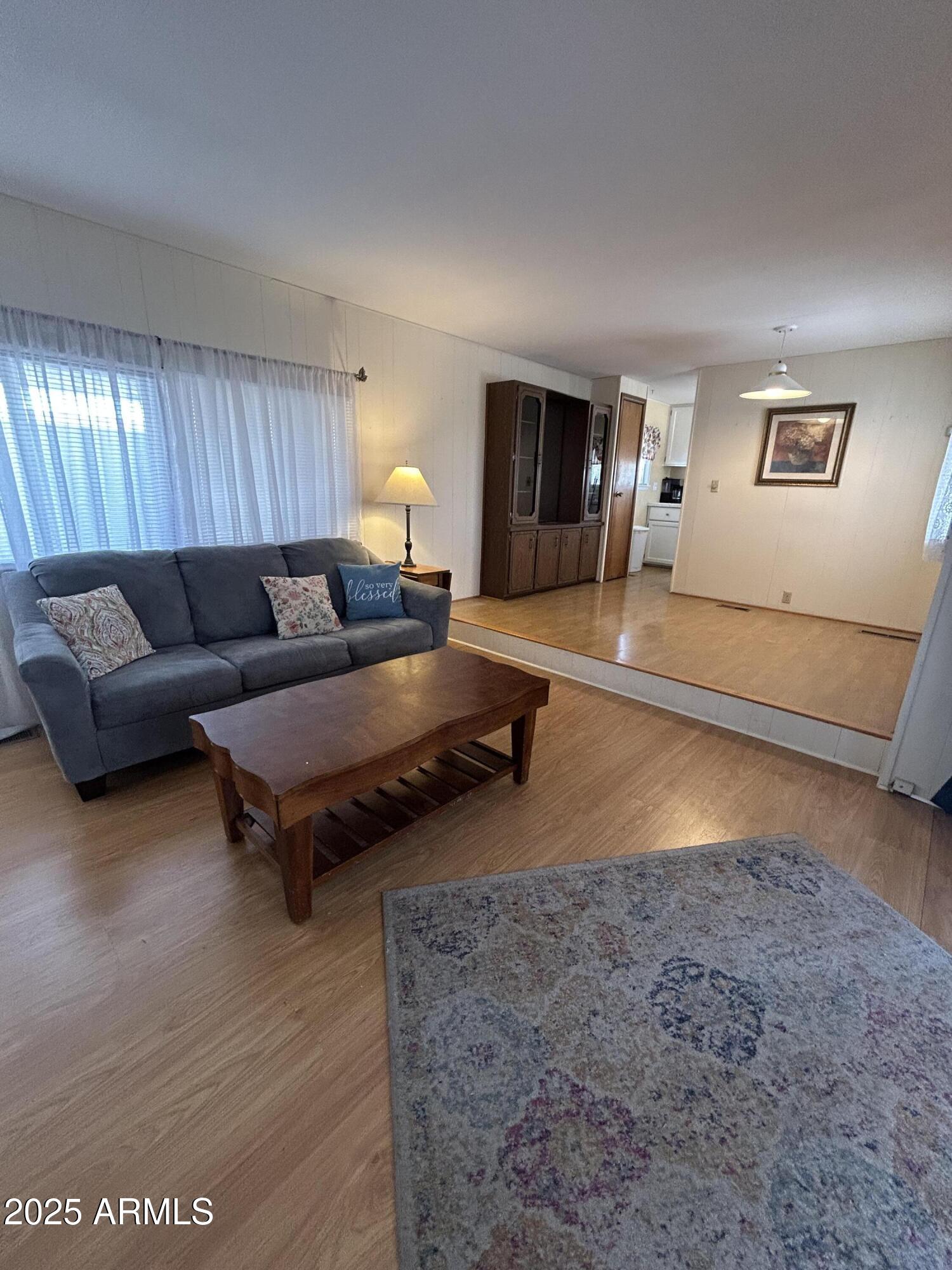 10220 East Apache Trail, Unit 28 Apache Junction, AZ 85120 - Photo 9 of 18 a living room with furniture and a wooden floor