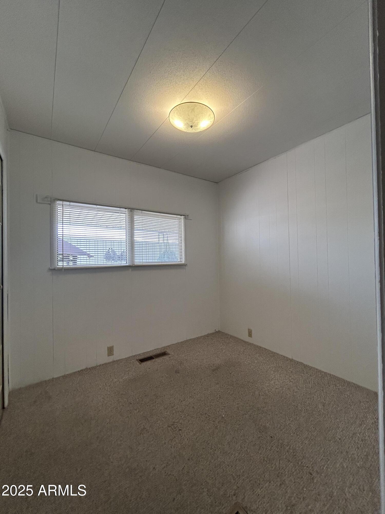 10220 East Apache Trail, Unit 28 Apache Junction, AZ 85120 - Photo 10 of 18 an empty room with a empty space and windows