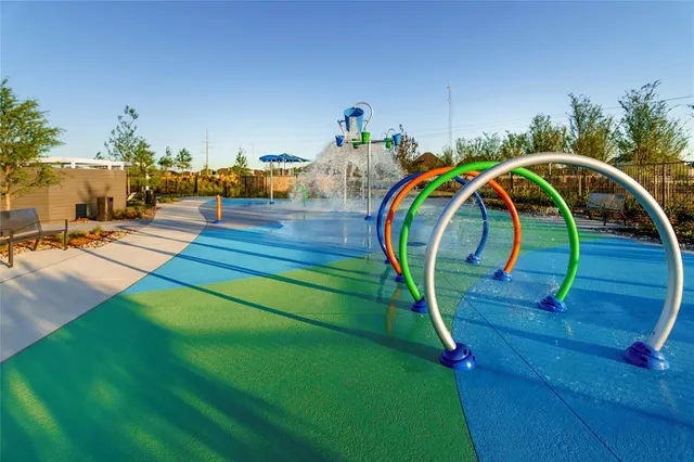 a front view of a house with a yard and green space