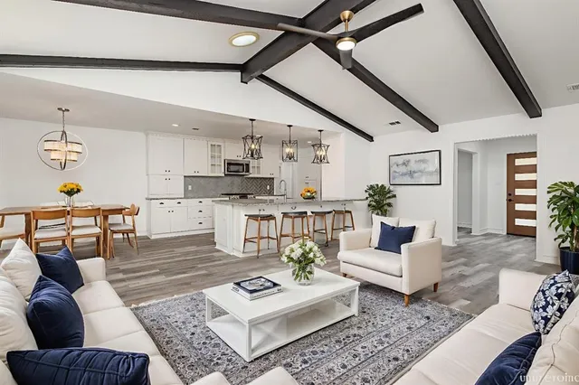 a living room with furniture and kitchen view