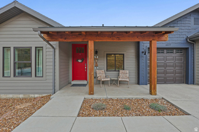 4527 North Seven Bridges Road Eden, UT 84310 - Photo 51 of 65 View of exterior entry featuring covered porch, a garage, and concrete driveway
