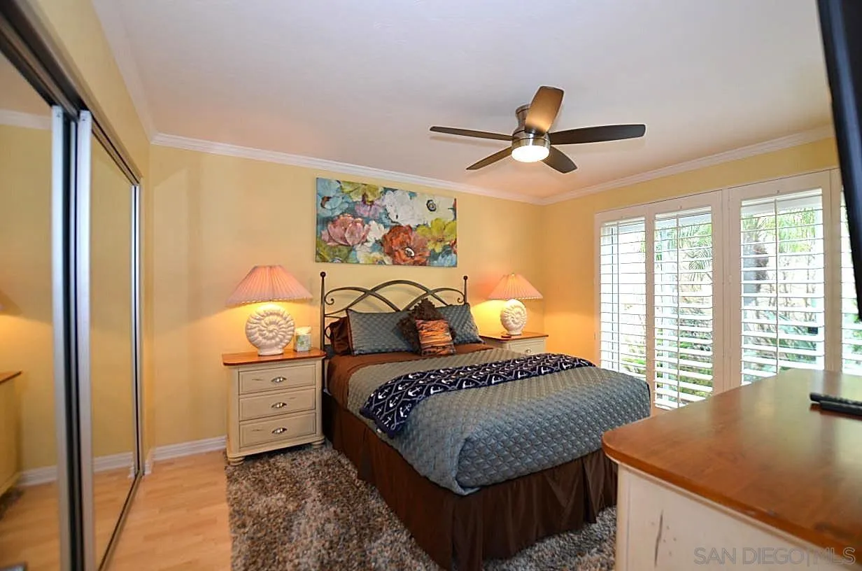 95 Port Of Spain Road Coronado, CA 92118 - Photo 11 of 40 a bedroom with a bed and a chandelier