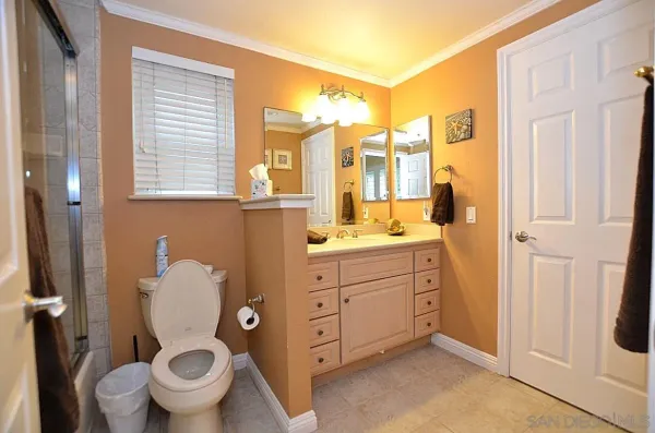 a bathroom with a granite countertop toilet sink and a shower