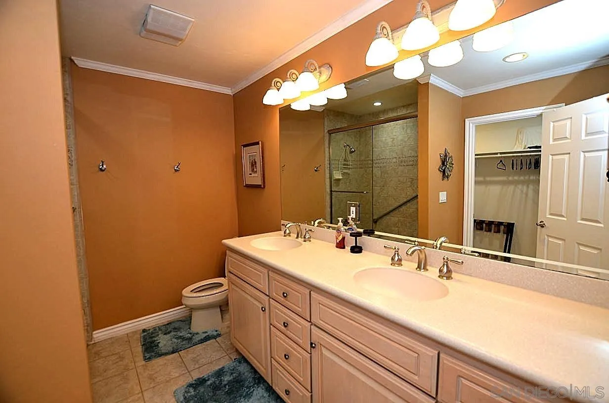 95 Port Of Spain Road Coronado, CA 92118 - Photo 21 of 40 a bathroom with a double vanity sink mirror and toilet