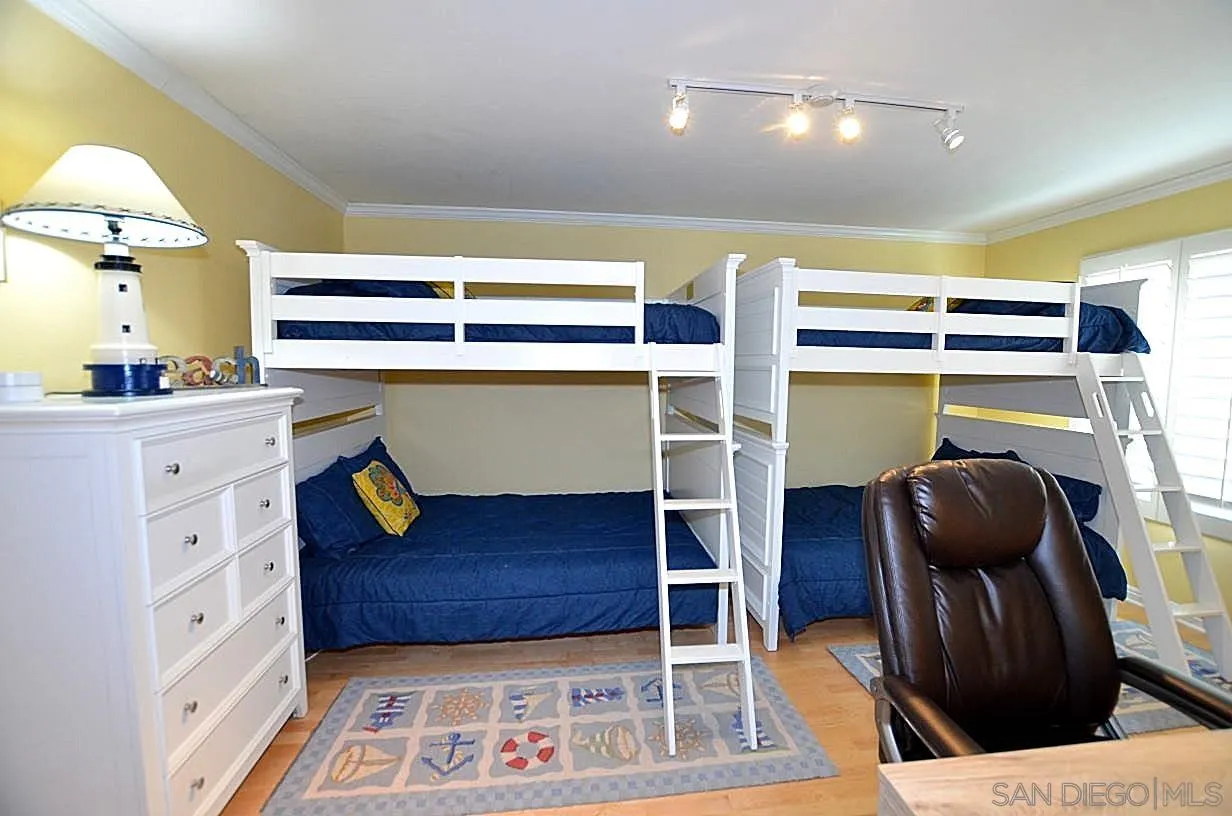 95 Port Of Spain Road Coronado, CA 92118 - Photo 25 of 40 a bedroom with a bed and a walk in closet