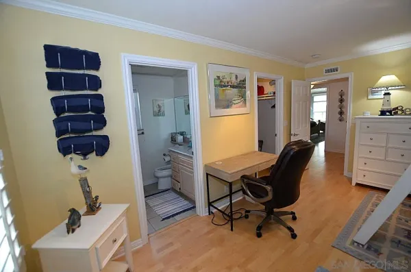 a view of a workspace with furniture and a window