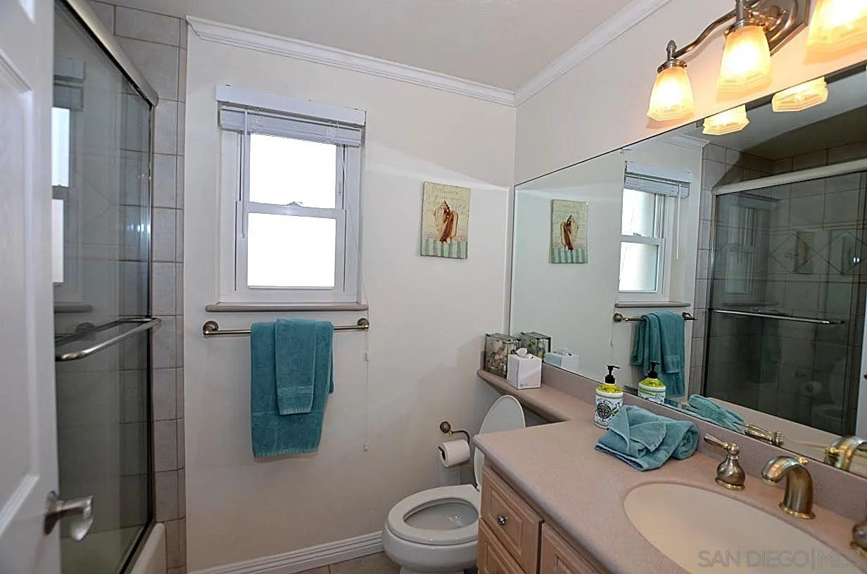 95 Port Of Spain Road Coronado, CA 92118 - Photo 27 of 40 a bathroom with a granite countertop sink toilet and shower
