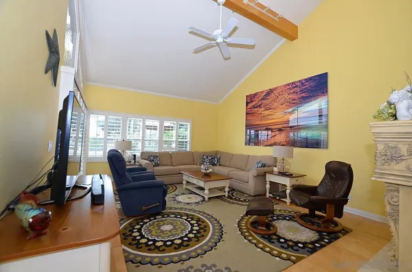 a work room with furniture a rug and a window