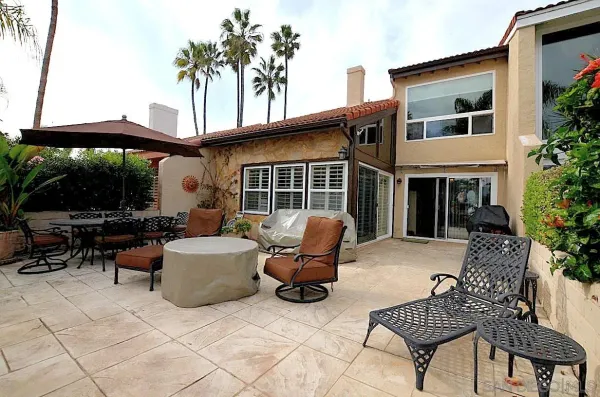 a view of a patio with couple of chairs
