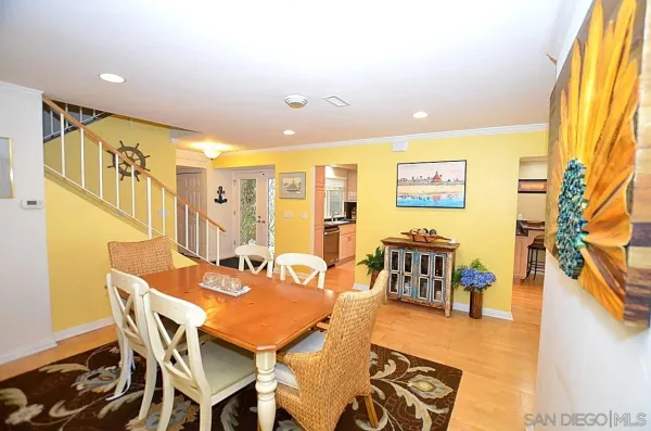 a dining room with furniture and a large window