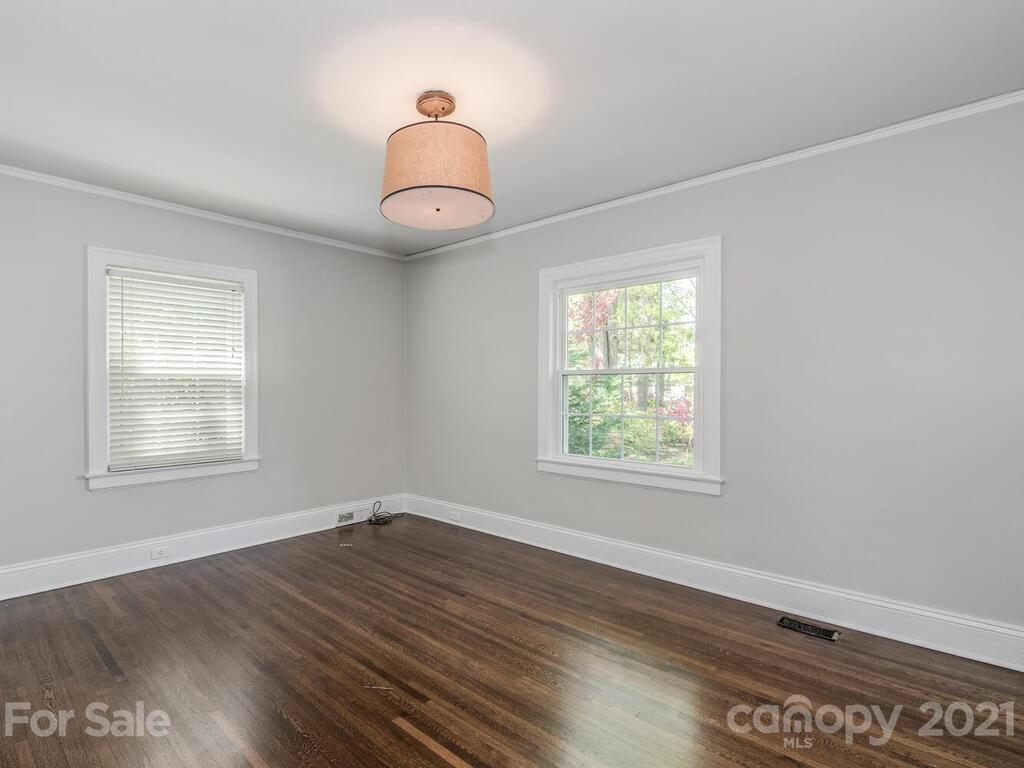 1408 Lilac Road Charlotte, NC 28209 - Photo 11 of 23 an empty room with wooden floor and windows