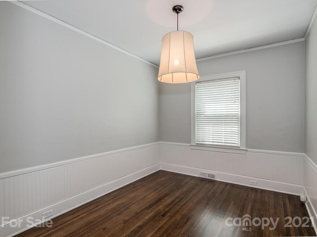 1408 Lilac Road Charlotte, NC 28209 - Photo 12 of 23 a view of an empty room with wooden floor and a window