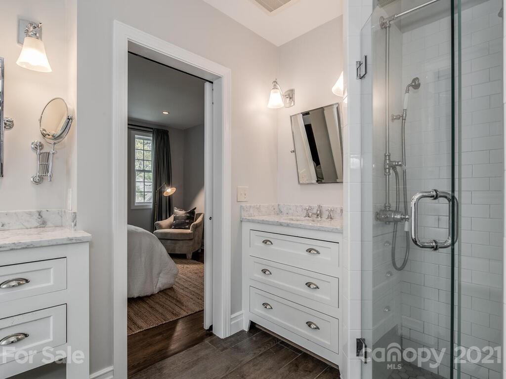 1408 Lilac Road Charlotte, NC 28209 - Photo 16 of 23 a bathroom with a shower a sink and mirror