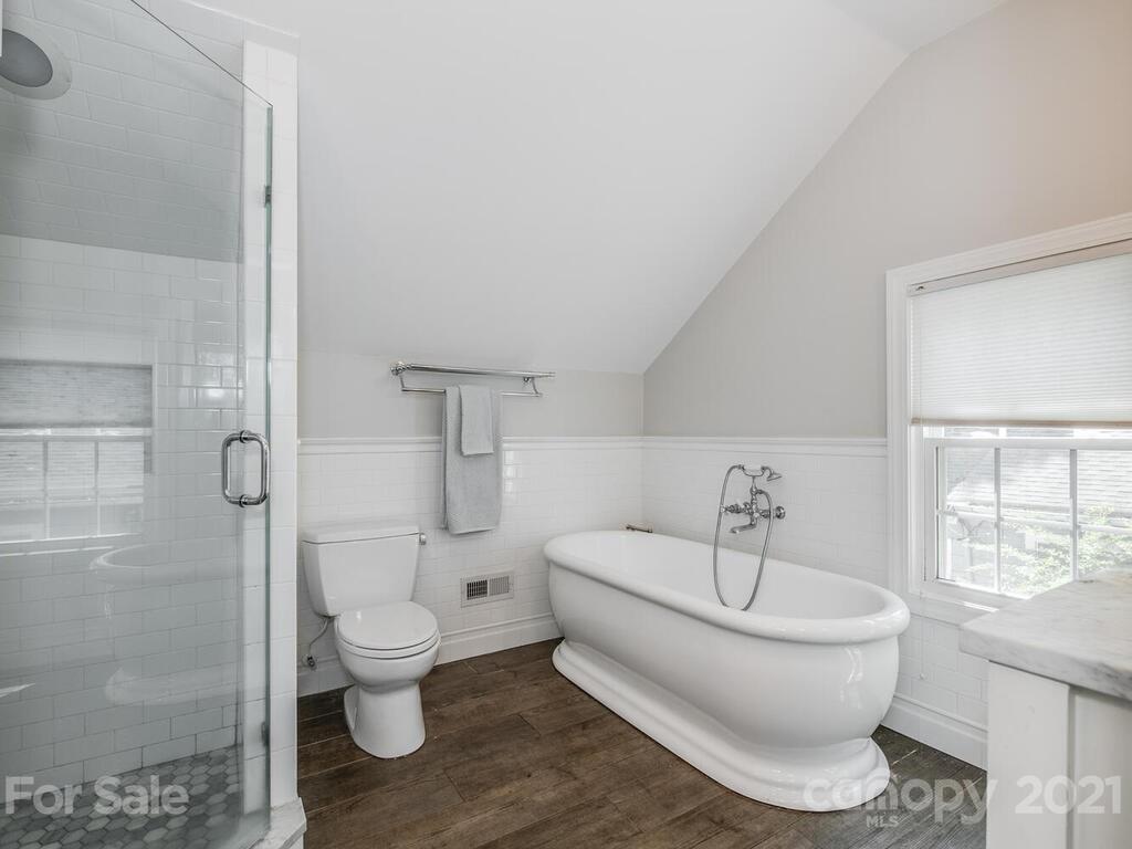 1408 Lilac Road Charlotte, NC 28209 - Photo 17 of 23 a white toilet sitting next to a bathroom sink