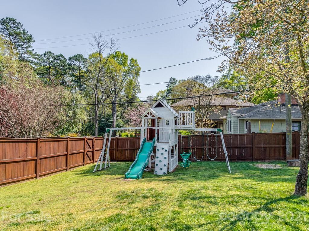 1408 Lilac Road Charlotte, NC 28209 - Photo 23 of 23 a view of backyard with wooden fence and a large tree