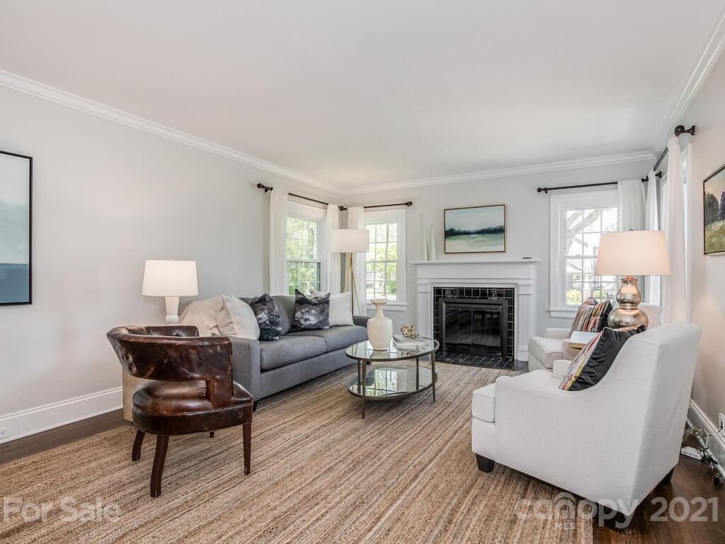 1408 Lilac Road Charlotte, NC 28209 - Photo 5 of 23 a living room with furniture a fireplace and a table