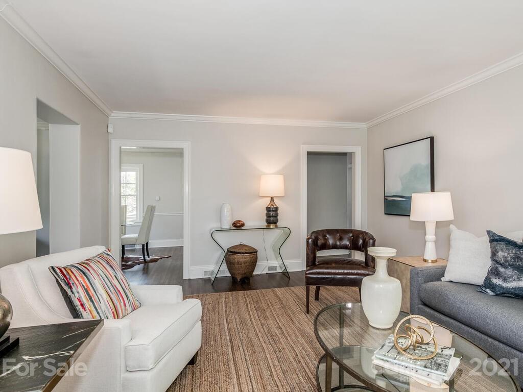 1408 Lilac Road Charlotte, NC 28209 - Photo 6 of 23 a living room with furniture a rug and a lamp