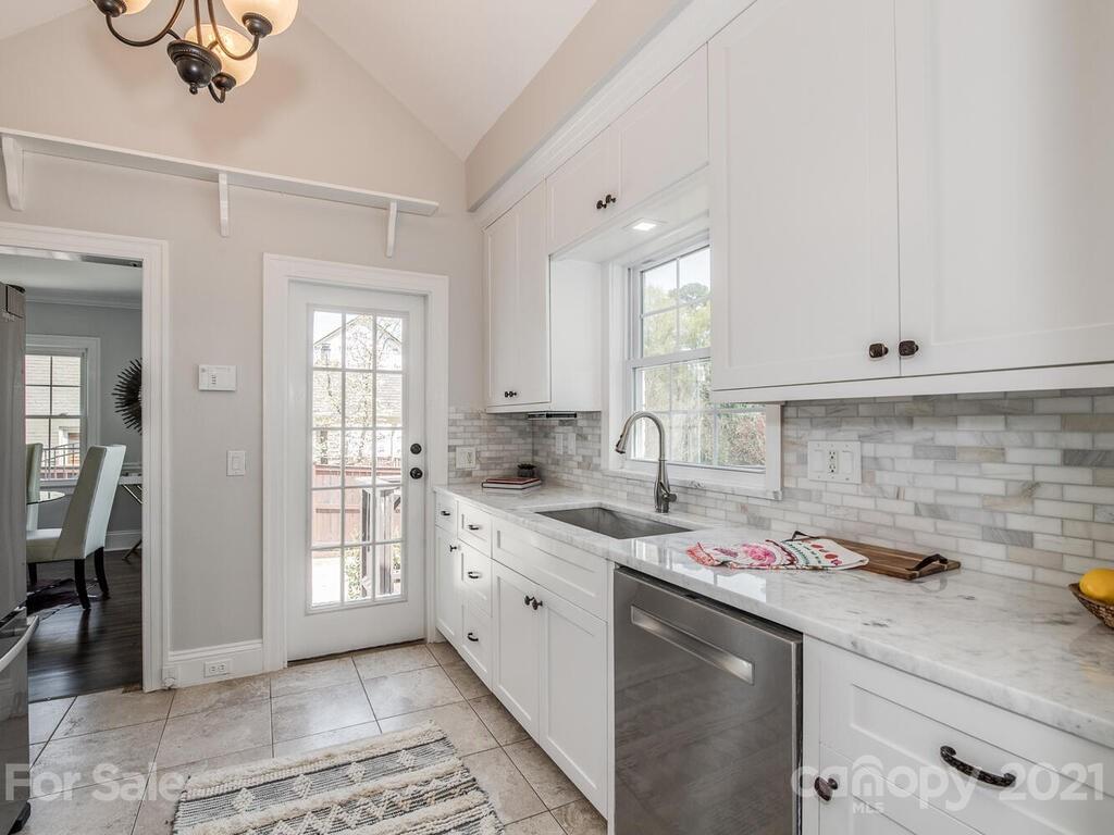 1408 Lilac Road Charlotte, NC 28209 - Photo 8 of 23 a kitchen with a sink window and cabinets