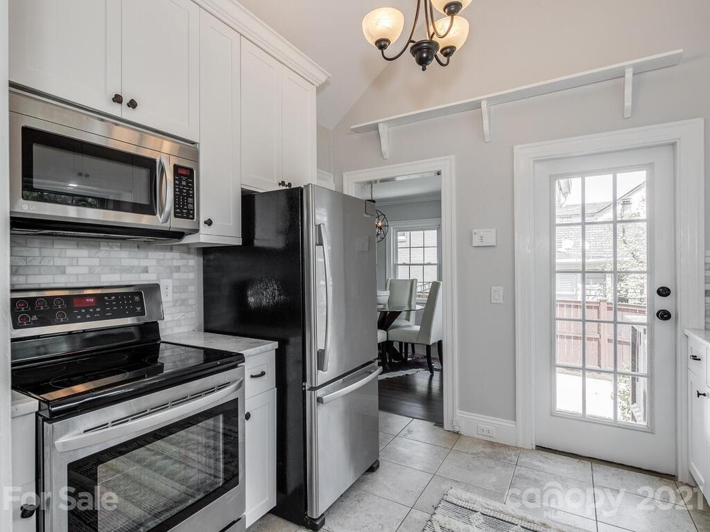 1408 Lilac Road Charlotte, NC 28209 - Photo 9 of 23 a kitchen with a refrigerator stove and microwave