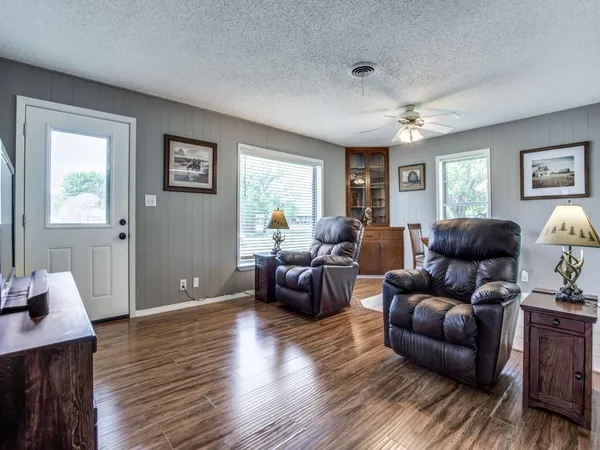 a living room with furniture and a wooden floor