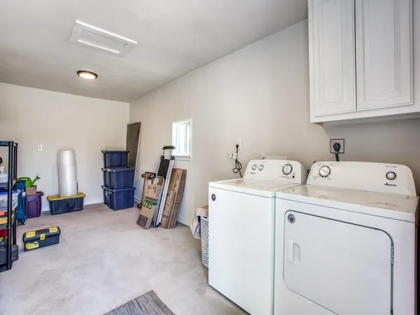 a view of storage and utility room with washer and dryer