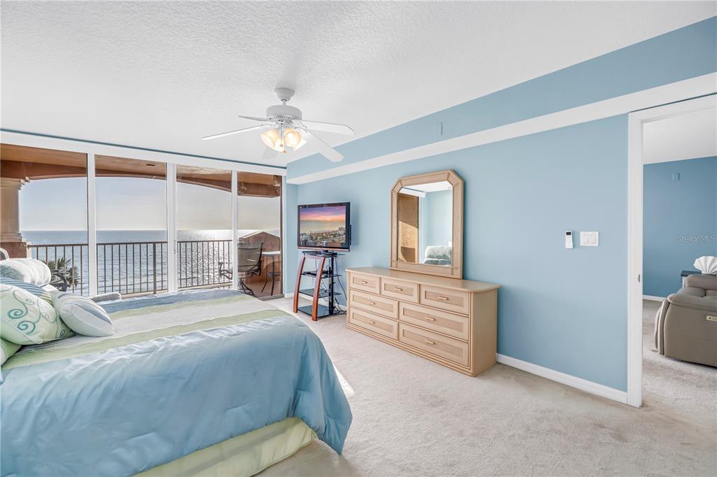 16326 Gulf Boulevard, Unit 308 Redington Beach, FL 33708 - Photo 17 of 44 a bedroom with a large bed and a chandelier