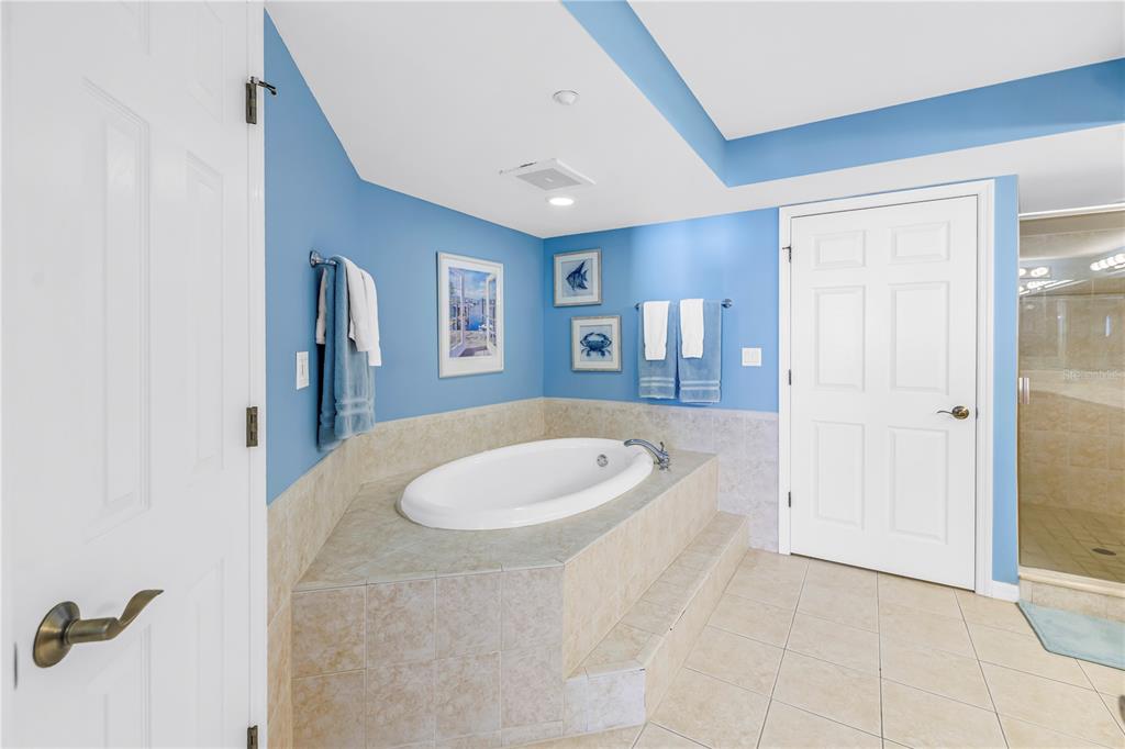 16326 Gulf Boulevard, Unit 308 Redington Beach, FL 33708 - Photo 19 of 44 a bathroom with a sink a mirror and a bathtub
