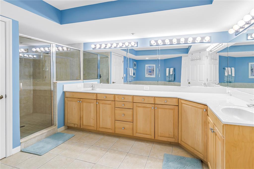 16326 Gulf Boulevard, Unit 308 Redington Beach, FL 33708 - Photo 21 of 44 a spacious bathroom with a granite countertop sink mirror and shower