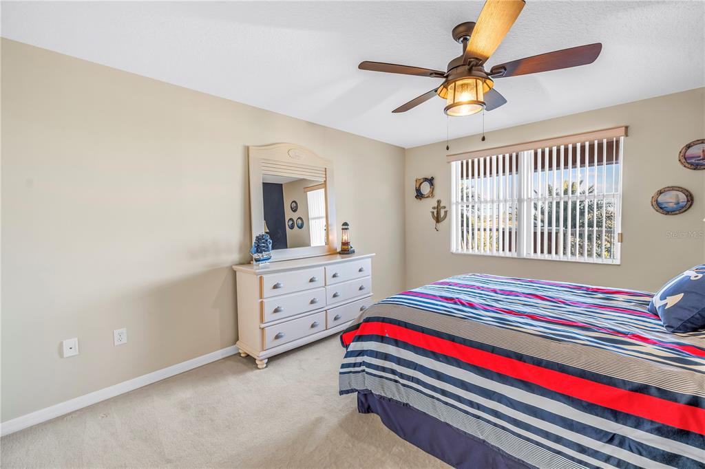 16326 Gulf Boulevard, Unit 308 Redington Beach, FL 33708 - Photo 23 of 44 a bedroom with a bed and a dresser