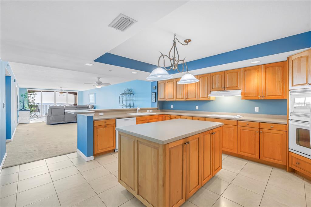 16326 Gulf Boulevard, Unit 308 Redington Beach, FL 33708 - Photo 6 of 44 a kitchen with stainless steel appliances granite countertop a sink counter space cabinets and a window
