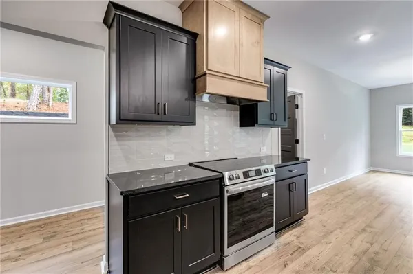 a kitchen with stainless steel appliances granite countertop a stove and a refrigerator