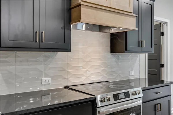 a stove top oven sitting inside of a kitchen