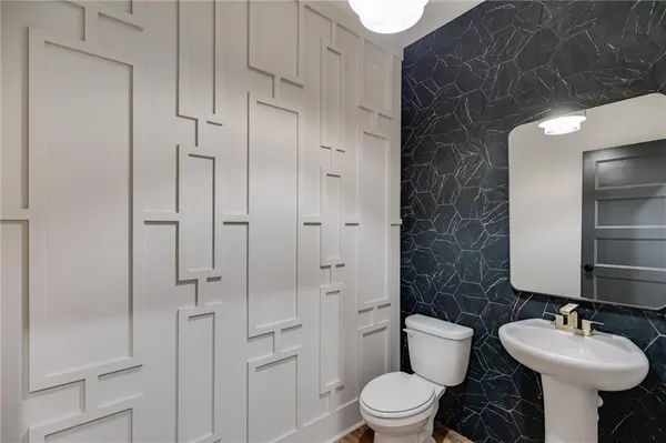 a bathroom with a toilet sink and shower