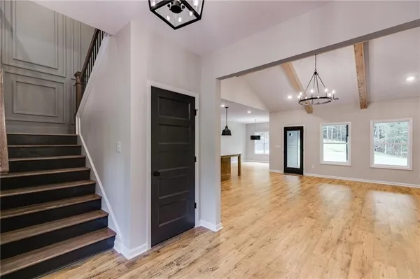 a view of an entryway with wooden floor and staircase
