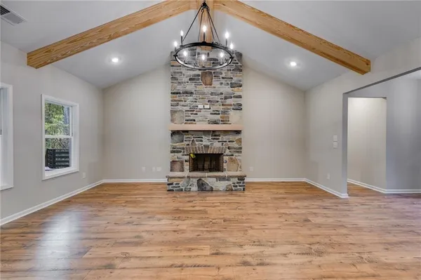 a view of a livingroom with a fireplace and window