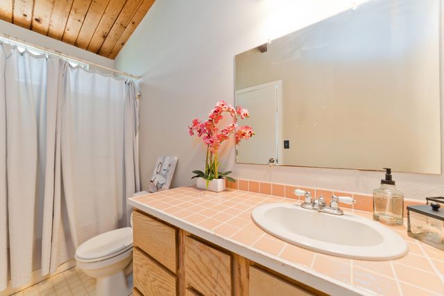 a bathroom with a sink toilet and a mirror