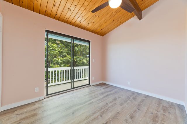 a view of a room with wooden floor and window