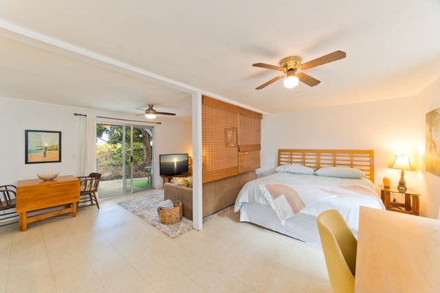 a bedroom with furniture and a chair